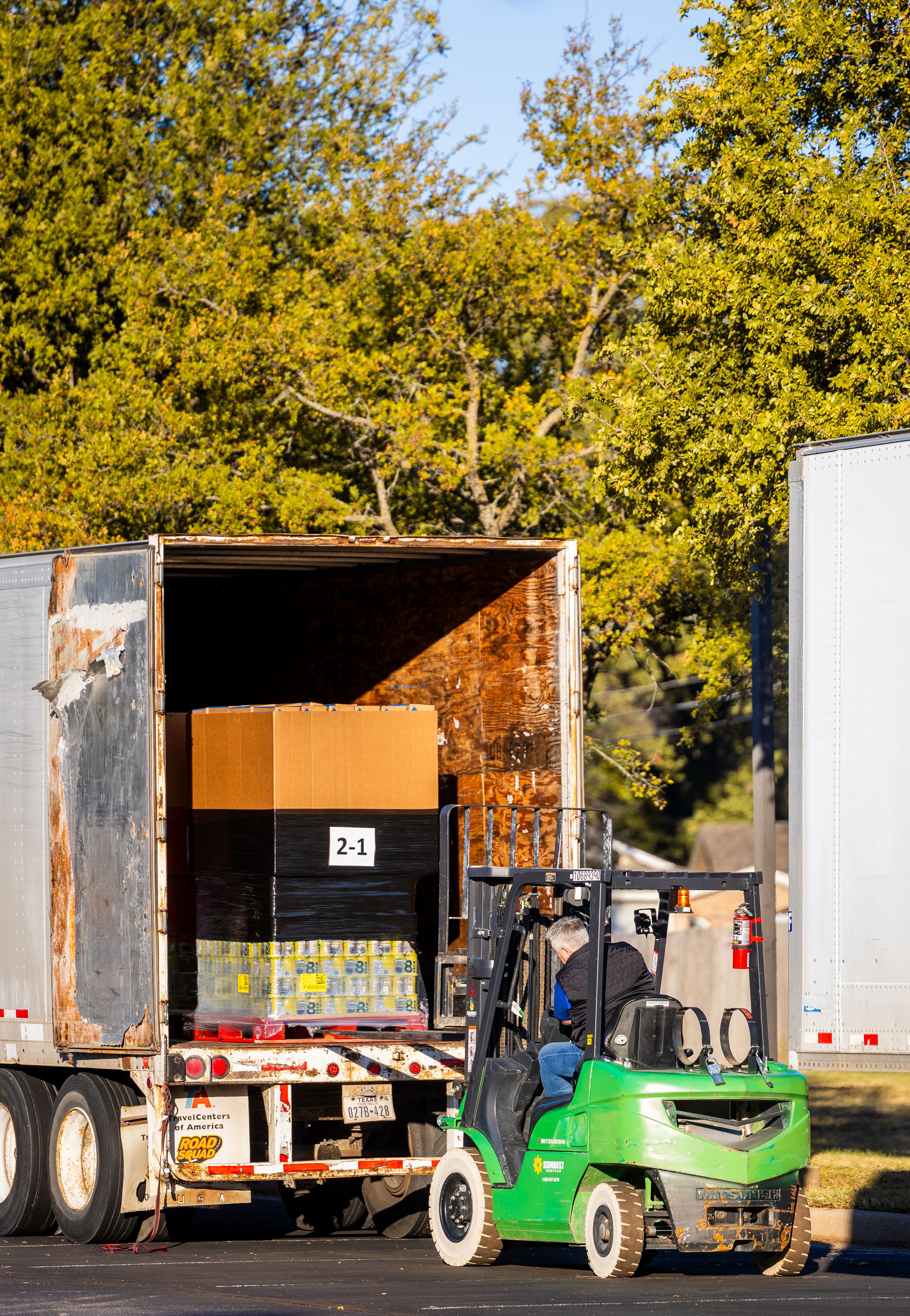 Forklift loading a pallet into a trailer