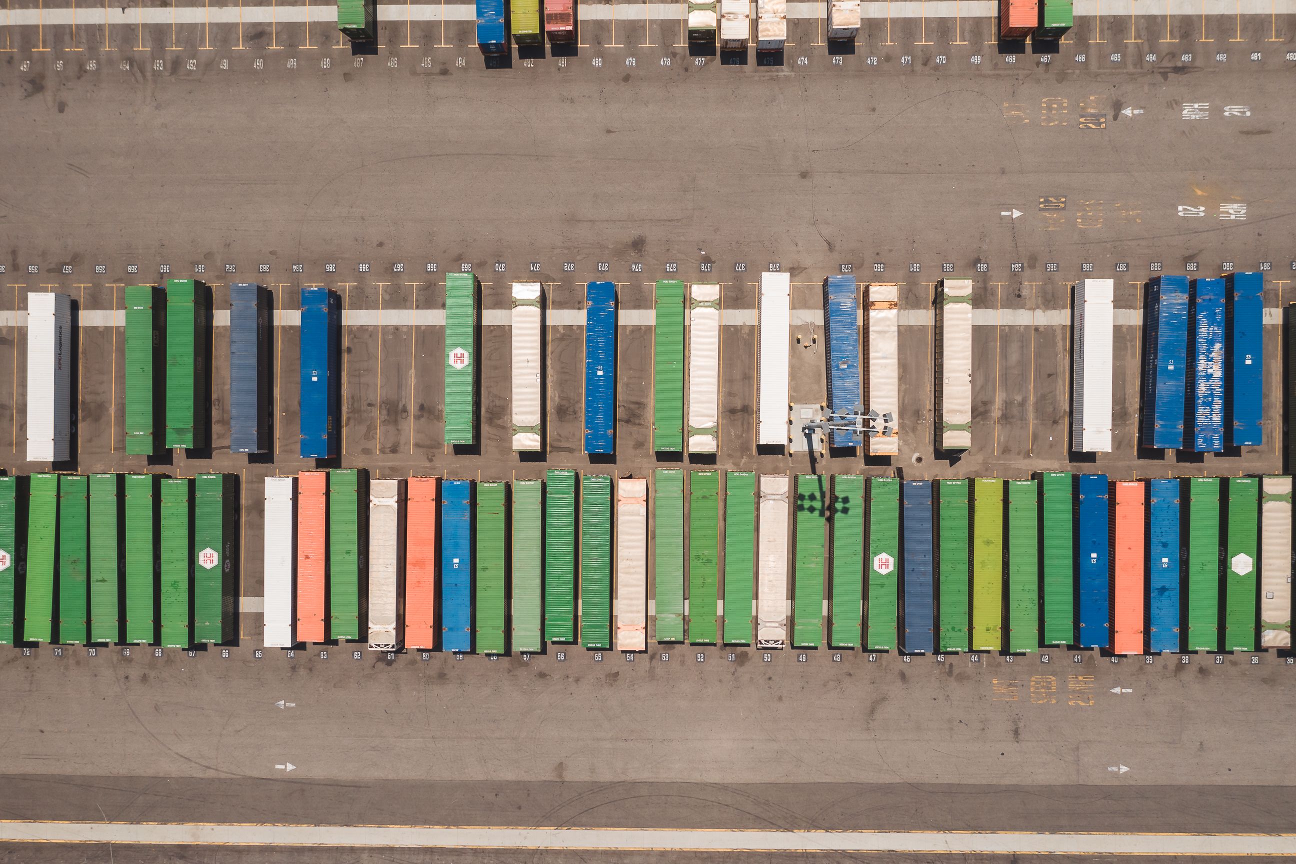 Aerial view of trailers backed into numbered dock bays