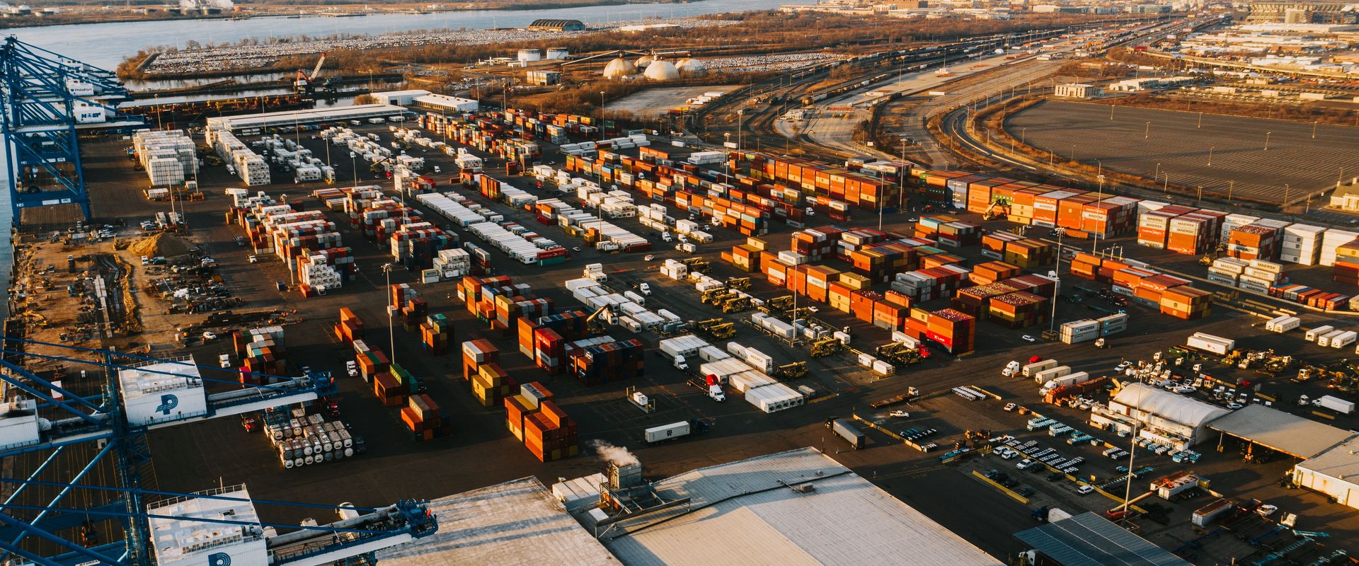 What is drayage? This: an aerial view of a container terminal where trucks pull boxes from the cranes to nearby warehouses, port drayage explained from above