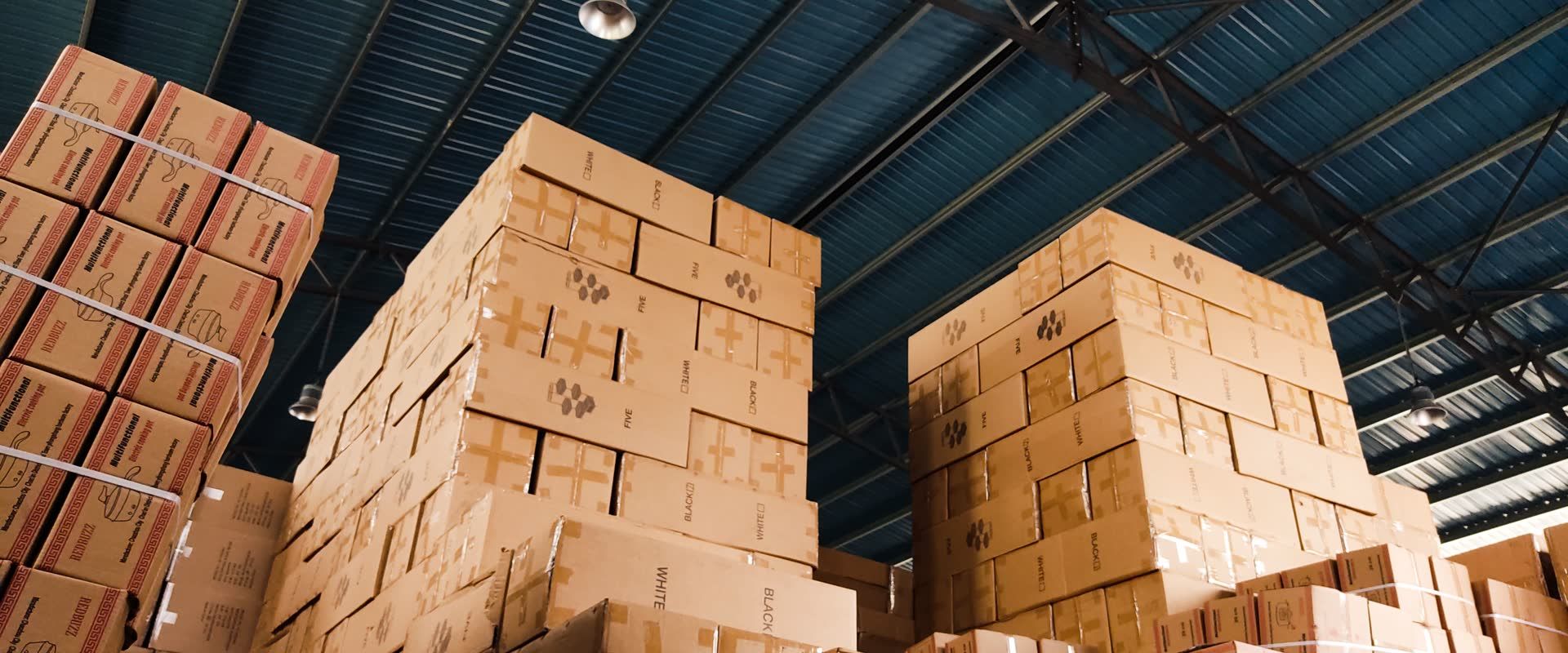 Cardboard cartons stacked in a warehouse, the everyday freight our freight shipping guides for shippers cover